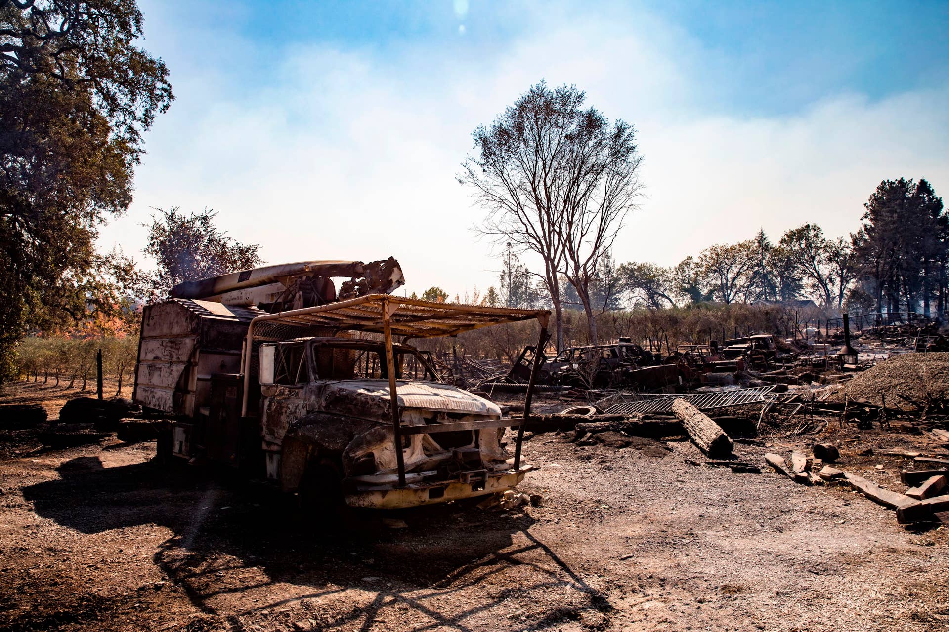 The smoldering remains of a utility truck sits on a property burned during the Kincade Fire, along Highway 128, in Healdsburg, California on October 28, 2019. - California's governor declared a state-wide emergency on October 27 as a huge wind-fueled blaze forced evacuations and massive power blackouts, threatening towns in the famed Sonoma wine region. (Photo by Philip Pacheco / AFP) (Photo by PHILIP PACHECO/AFP via Getty Images)