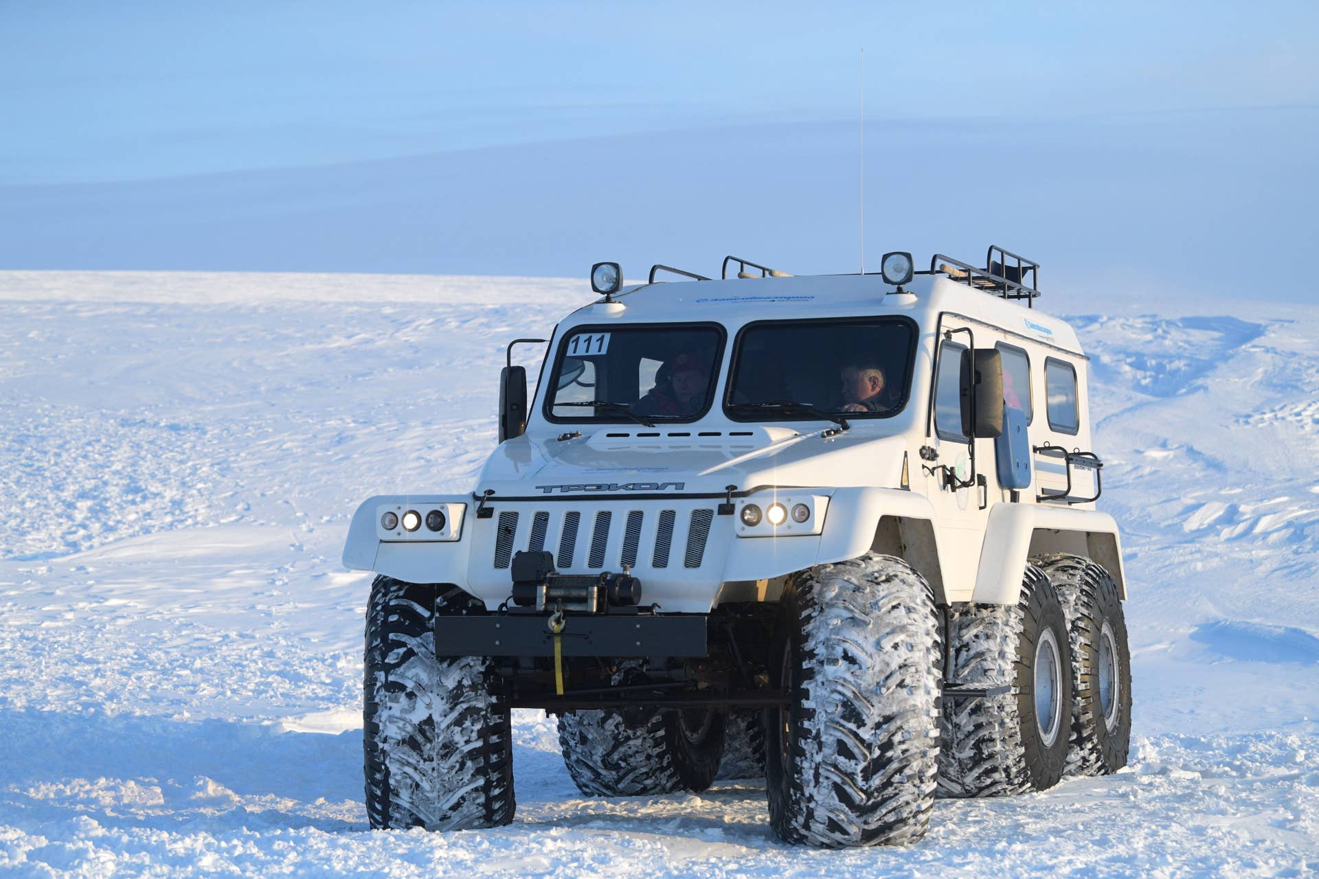 ARKHANGELSK REGION, RUSSIA - MARCH 29, 2017: Russia's President Vladimir Putin (L) seen in an all-terrain vehicle at Severnaya Bay of Alexandra Land Island, a part of the Franz Josef Land Archipelago. Putin has arrived on the island to inspect the results of work done by participants in an ecological expedition. Alexei Druzhinin/Russian Presidential Press and Information Office/TASS (Photo by Alexei DruzhininTASS via Getty Images)