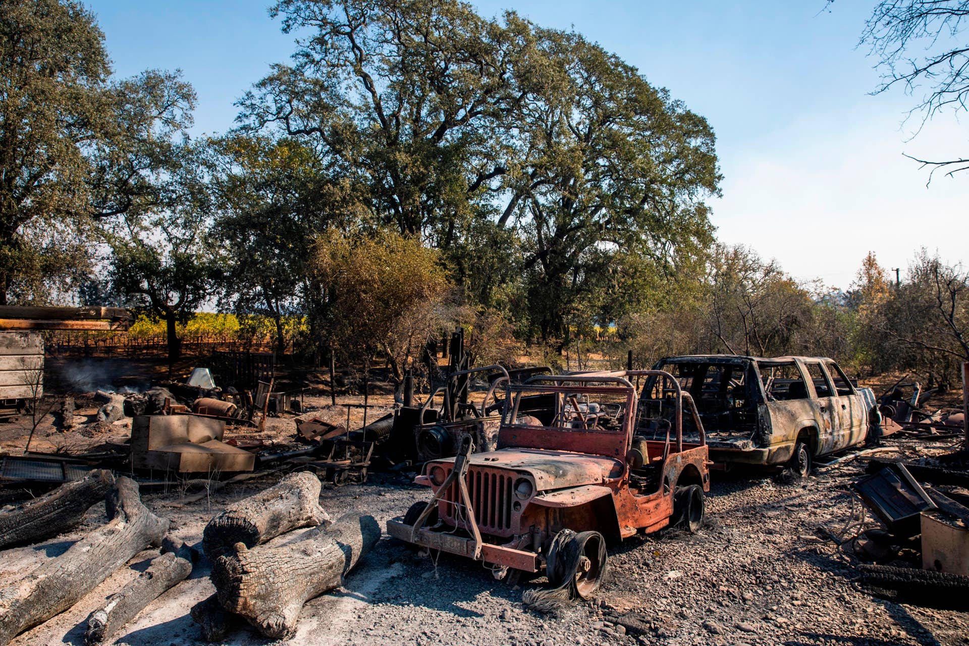 The charred remains of vehicles sit on a property burned during the Kincade Fire, along Highway 128 at  in Healdsburg, California on October 28, 2019. - California's governor declared a state-wide emergency on October 27 as a huge wind-fueled blaze forced evacuations and massive power blackouts, threatening towns in the famed Sonoma wine region. (Photo by Philip Pacheco / AFP) (Photo by PHILIP PACHECO/AFP via Getty Images)