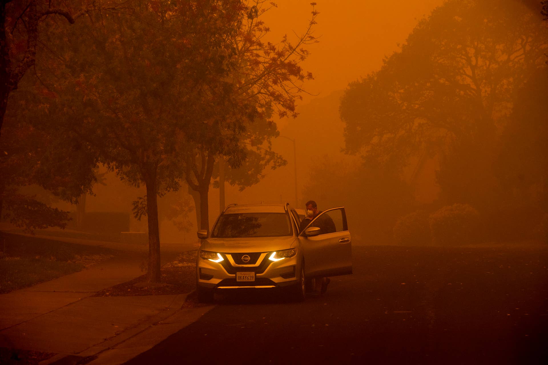 Smoke hangs over a residential neighborhood as a wildfire called the Kincade Fire burns in Healdsburg, Calif., Sunday, Oct. 27, 2019. (AP Photo/Noah Berger)