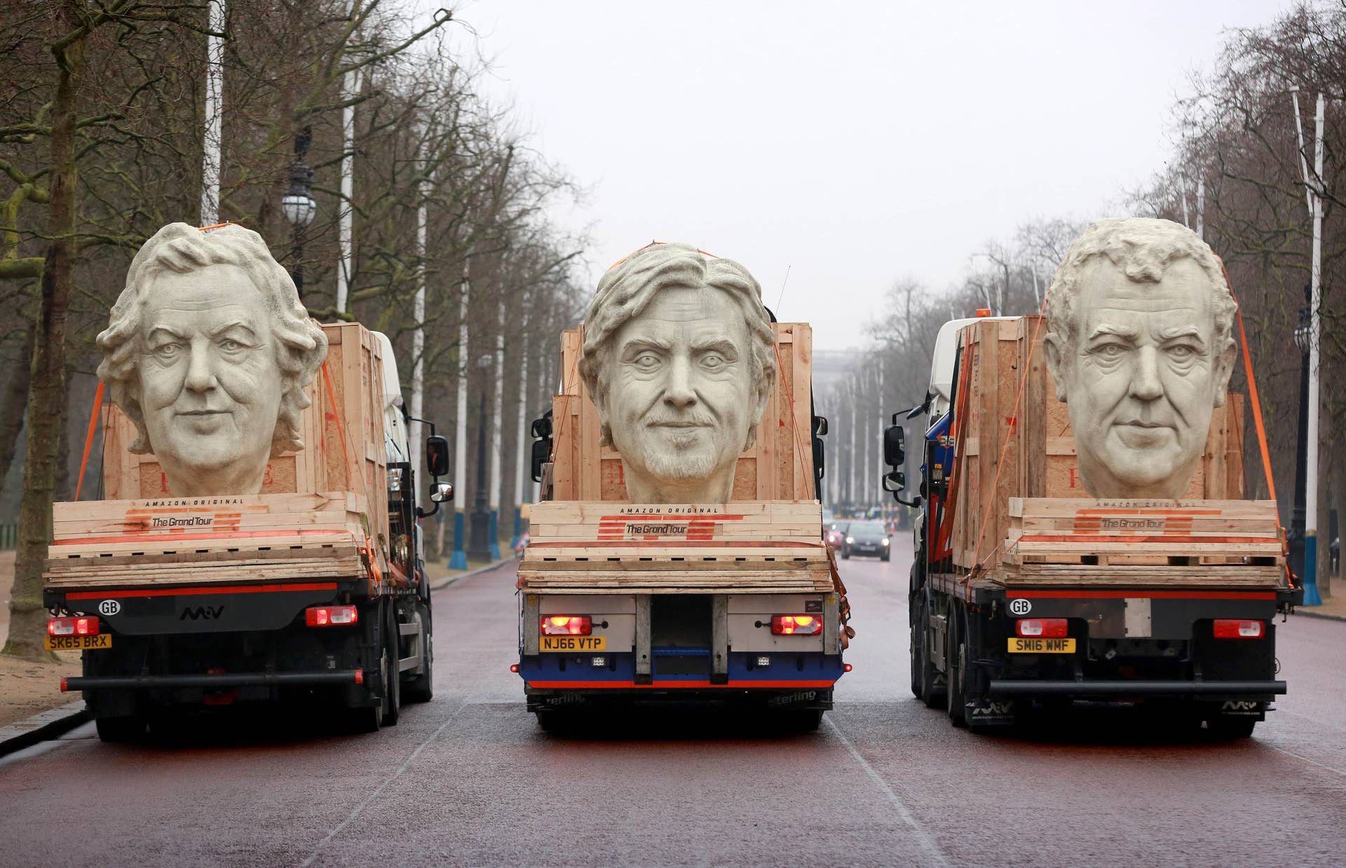EDITORIAL USE ONLY Three 8 foot models of the heads of The Grand Tour presenters, Jeremy Clarkson, James May and Richard Hammond travel down The Mall in London on the back of flatbed trucks after travelling 30,000 miles across 3 continents.
