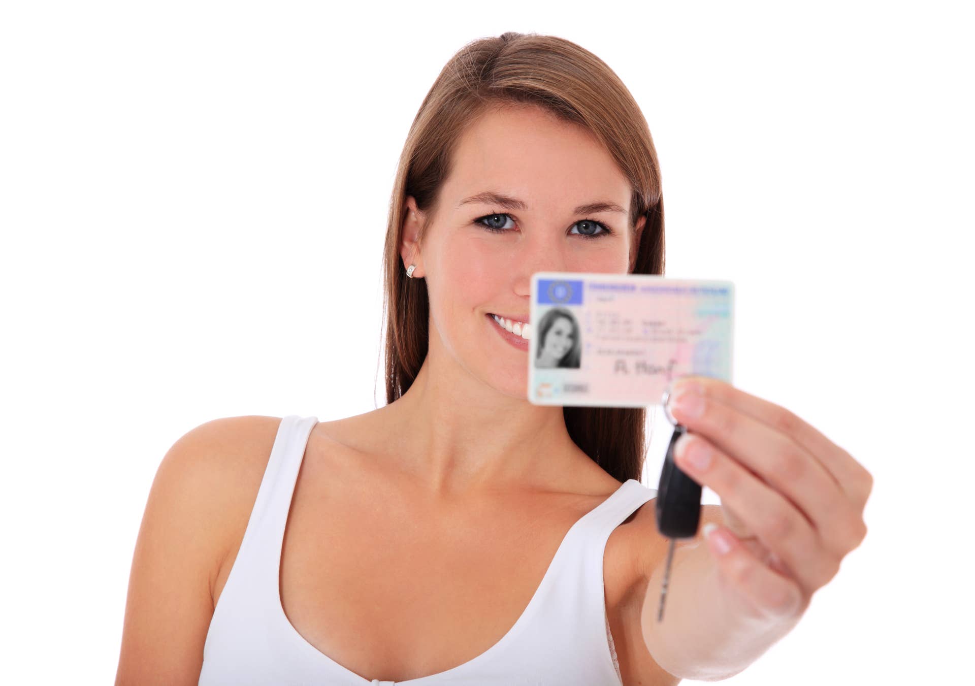 Attractive young woman showing her european driver license. All on white background.