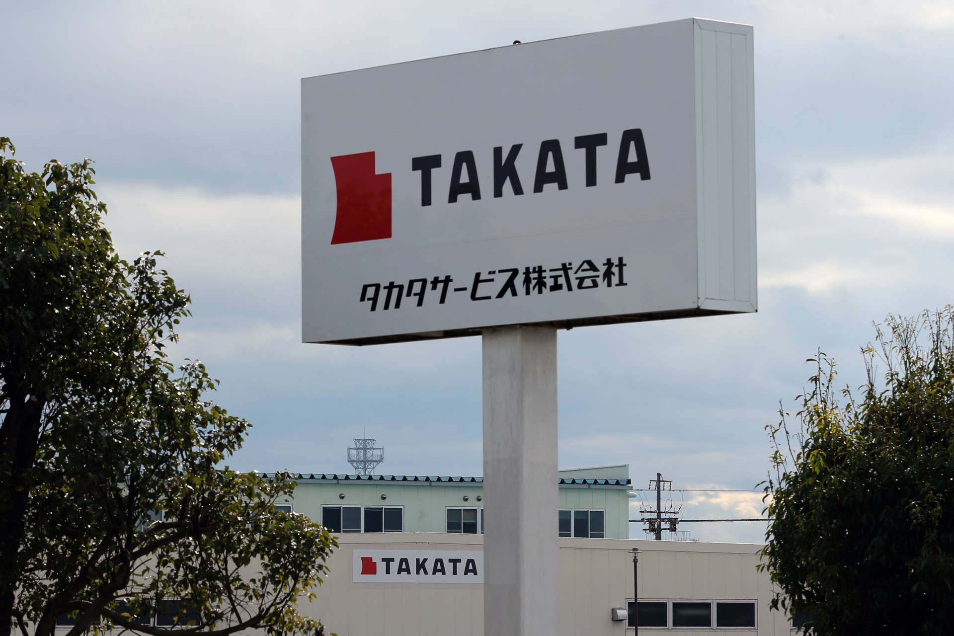 Signage for Takata Corp. are displayed at the company's Hikone plant in Hikone, Shiga, Japan, on Friday, Nov. 25, 2016. Takata's selection of a bidder is running behind schedule as the shortlisted companies embark on a more thorough review of the air-bag maker behind the biggest auto safety recall, according to people familiar with the matter. Photographer: Buddhika Weerasinghe/Bloomberg via Getty Images