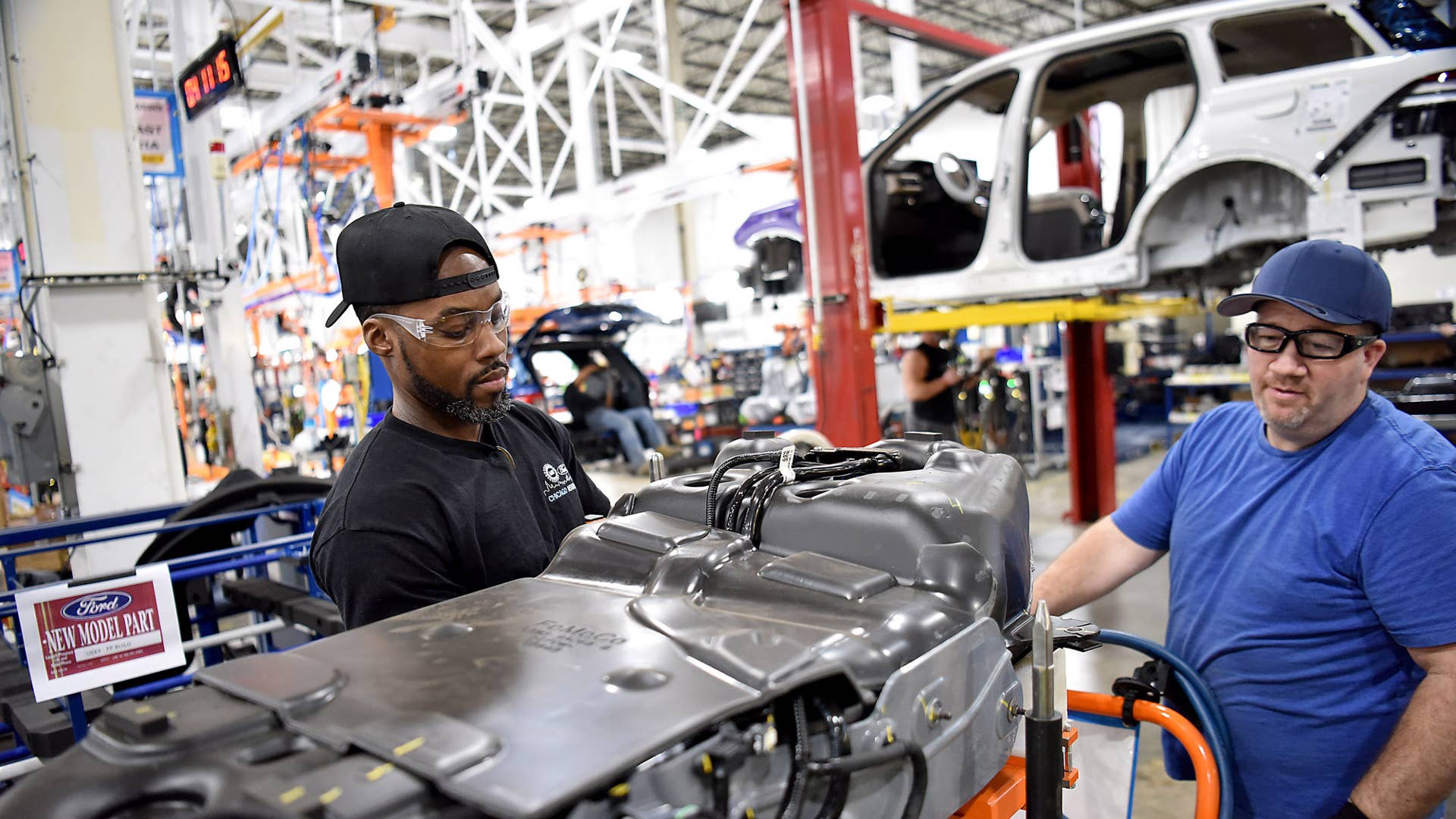 Sam Cravens (left) and Ron McDowell, Ford employees, train to build the all-new 2020 Ford Explorer.