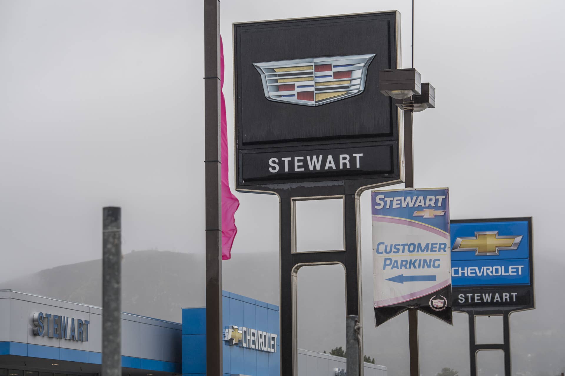 General Motors Co. (GM) Cadillac and Chevrolet brand signage is displayed outside of the Stewart Chevrolet dealership in Colma, California, U.S., on Monday, Feb. 6, 2017. General Motors is scheduled to release earnings figures on Feb. 7. Photographer: David Paul Morris/Bloomberg via Getty Images