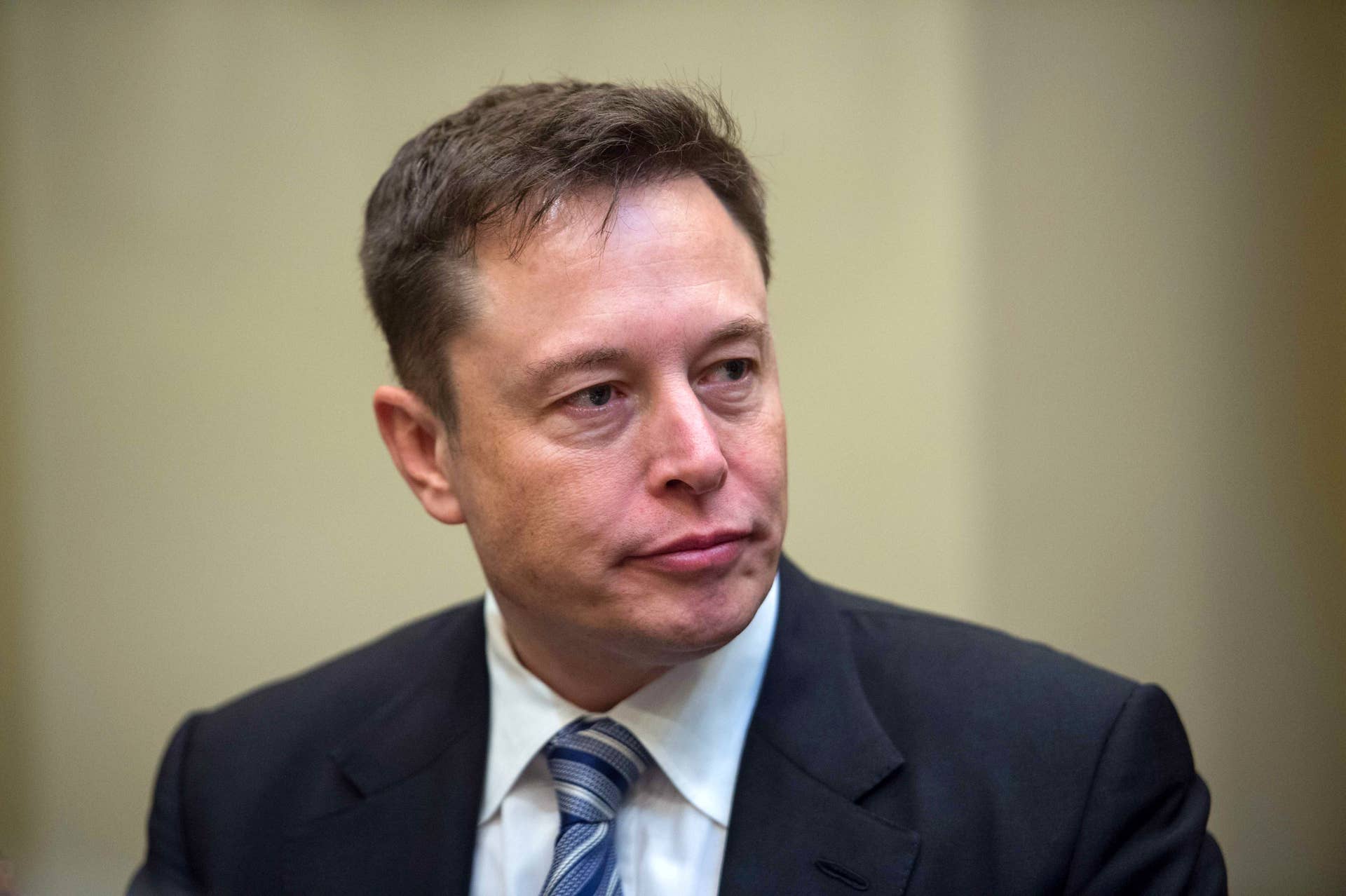 SpaceX CEO Elon Musk listens to US President Donald Trump speaks during a meeting with business leaders in the Roosevelt Room at the White House in Washington, DC, on January 23, 2017. / AFP / NICHOLAS KAMM (Photo credit should read NICHOLAS KAMM/AFP/Getty Images)