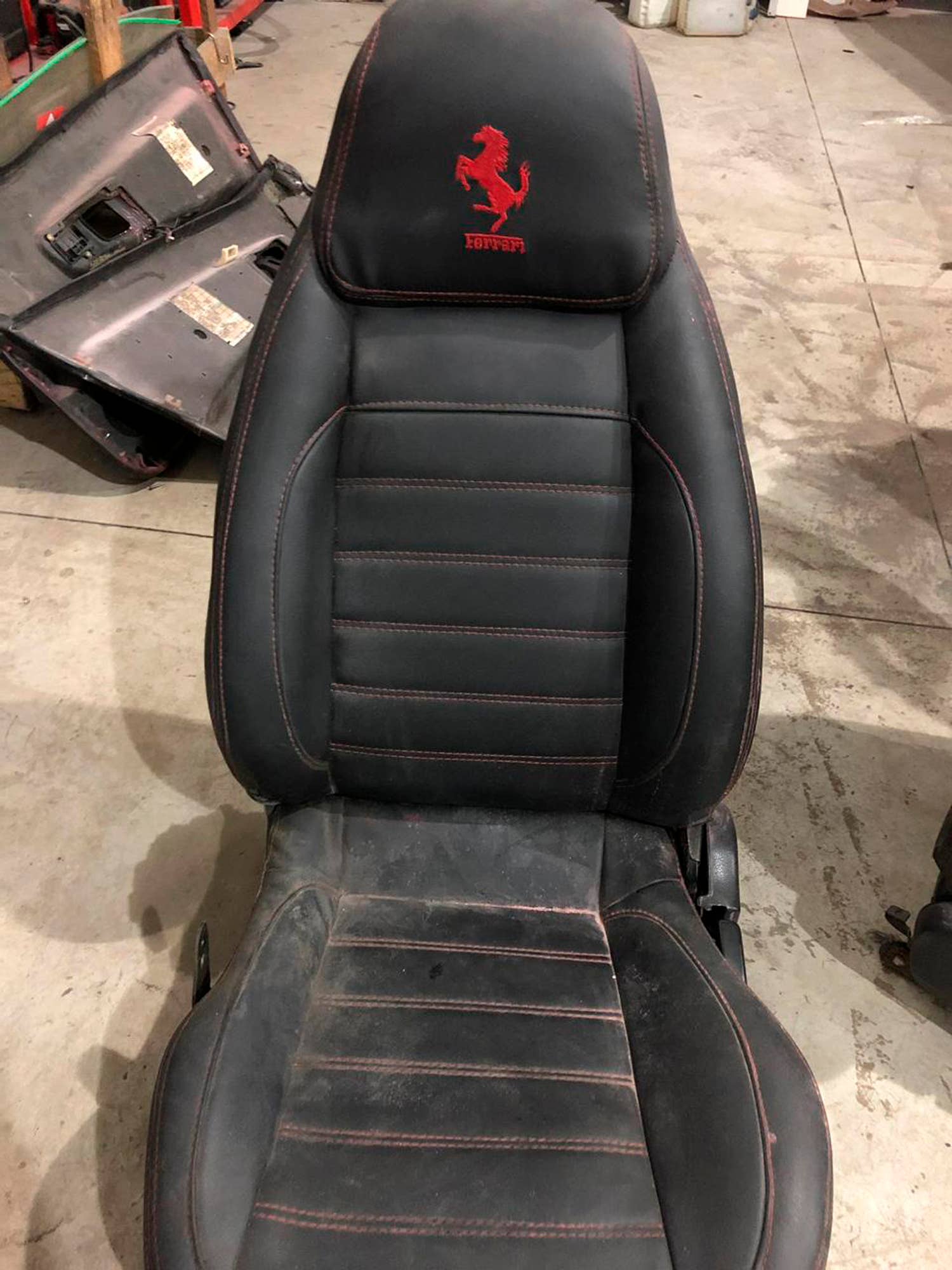 This July 15, 2019 photo released by Itajai Civil Police shows the seat of a car embroidered with a fake Ferrari logo,  inside a workshop in Itajai, Brazil. Brazilian police dismantled the clandestine workshop run by a father and son who assembled fake Ferraris and Lamborghinis to order, in Brazil's southern state of Santa Catarina. (Itajai Civil Police via AP)