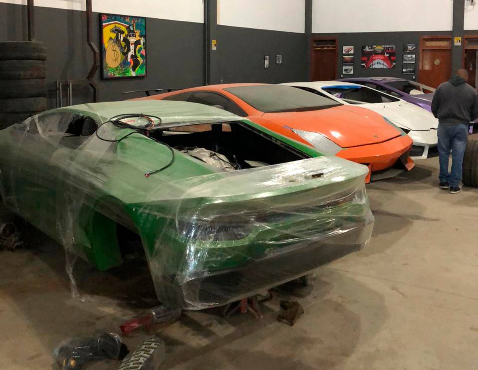 This July 15, 2019 photo released by Itajai Civil Police, shows car molds of luxury car replicas at a workshop in Itajai, Brazil. Brazilian police dismantled a clandestine workshop run by a father and son who assembled fake Ferraris and Lamborghinis to order, in Brazil's southern state of Santa Catarina. (Itajai Civil Police via AP)
