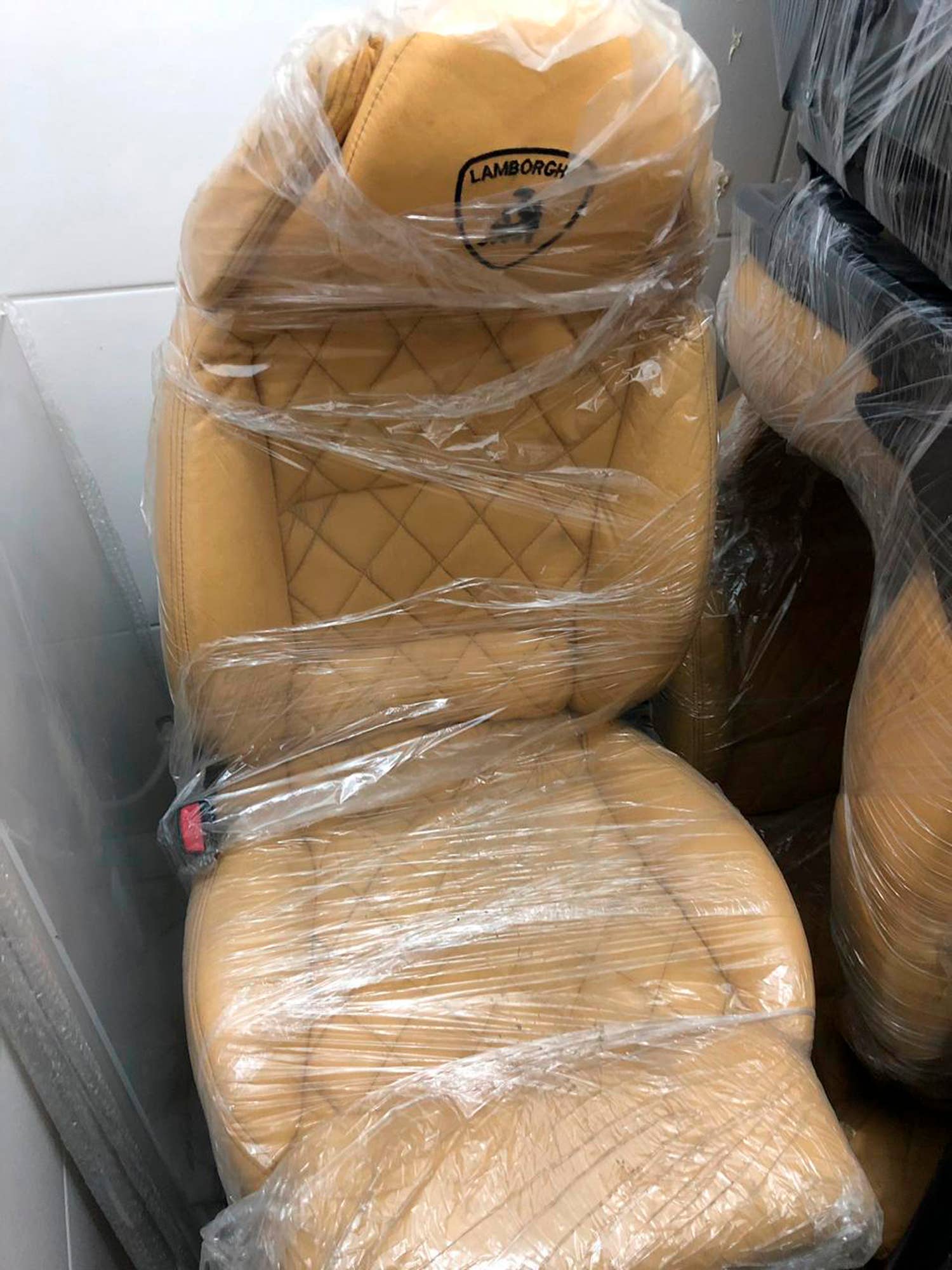 This July 15, 2019 photo released by Itajai Civil Police shows the seat of a car embroidered with a fake Lamborghini logo, inside a workshop in Itajai, Brazil. Brazilian police dismantled the clandestine workshop run by a father and son who assembled fake Ferraris and Lamborghinis to order, in Brazil's southern state of Santa Catarina. (Itajai Civil Police via AP) (Itajai Civil Police via AP)