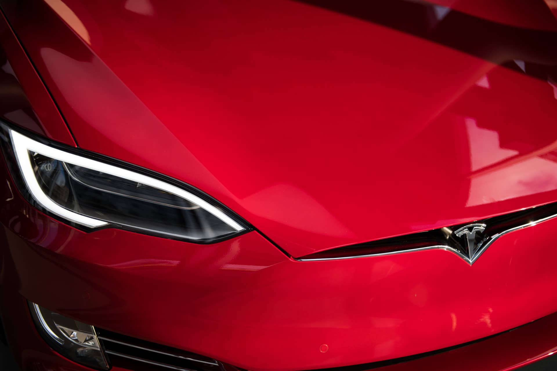 The headlight of a Tesla Inc. Model S P100D sedan vehicle is seen at the company's new showroom in New York, U.S., on Thursday, Dec. 14, 2017. The Meatpacking District location, which opens to the public at 11 a.m. Friday, lets customers for the first time explore energy offerings, configure cars and place orders all under one roof. Photographer: Mark Kauzlarich/Bloomberg via Getty Images