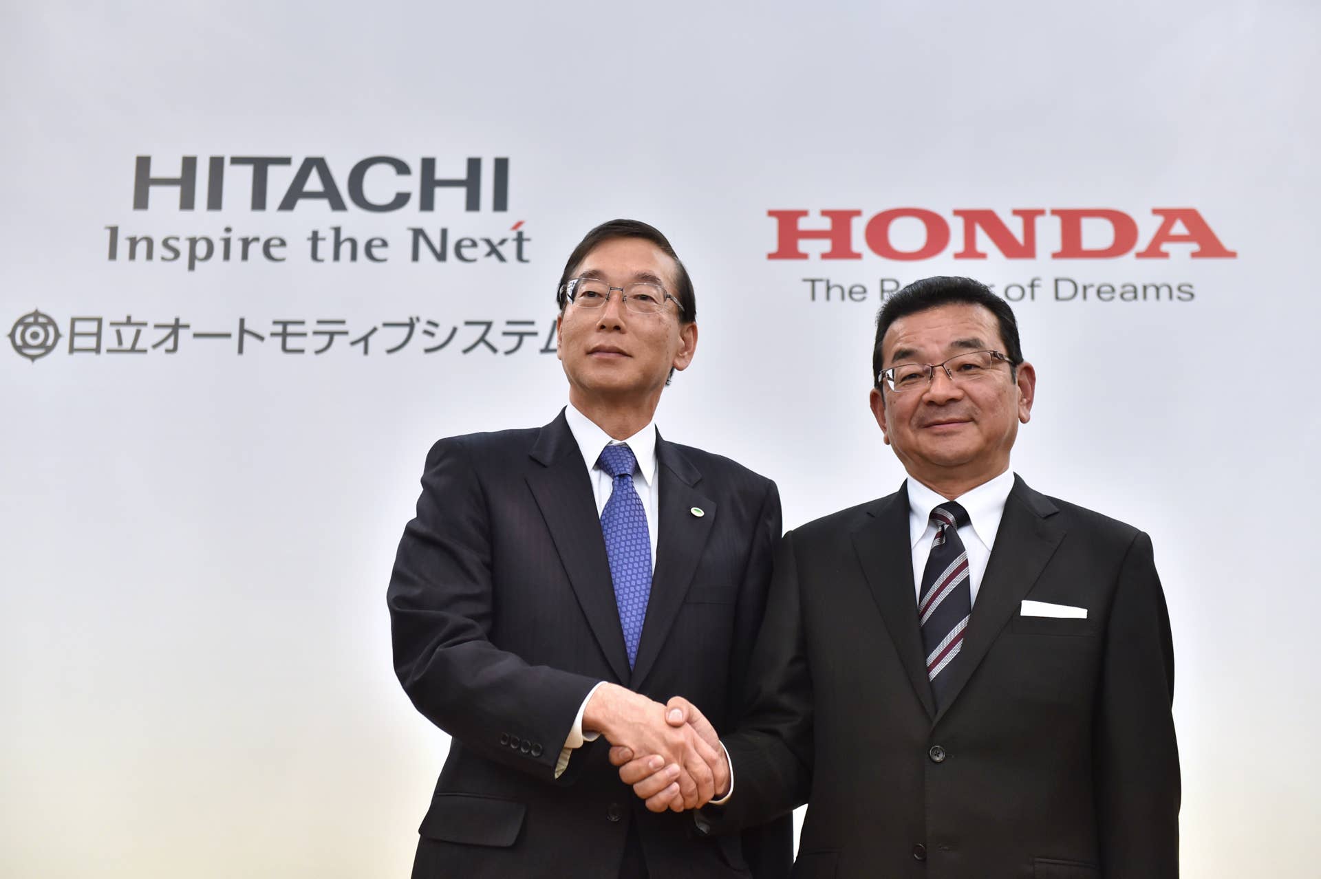 Honda Motor President, CEO and representative director Takahiro Hachigo (R) shakes hands with Hitachi Automotive Systems President and CEO Hideki Seki (L) following their joint press conference in Tokyo on February 7, 2017. Japanese automaker Honda announced February 7 a joint venture with Hitachi Automotive Systems, a subsidiary of the industrial conglomerate, to collaborate in the field of electric and hybrid vehicles. / AFP / KAZUHIRO NOGI (Photo credit should read KAZUHIRO NOGI/AFP/Getty Images)
