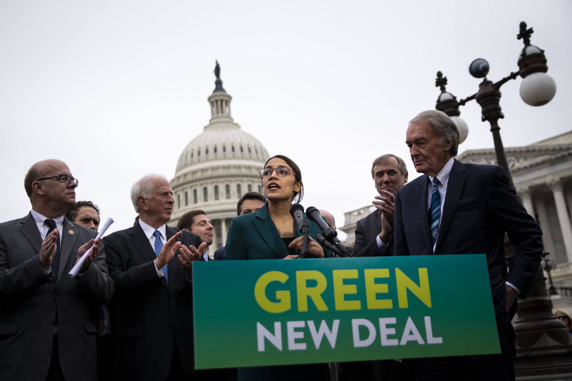 Representative Alexandria Ocasio-Cortez, a Democrat from New York, speaks as Senator Ed Markey, a Democrat from Massachusetts, right, listens during a news conference announcing Green New Deal legislation in Washington, D.C., U.S., on Thursday, Feb. 7, 2019. A sweeping package of climate-change measures unveiled Thursday by Ocasio-Cortez drew a tepid response from House Speaker Nancy Pelosi who didn't explicitly throw her support behind the measure. Photographer: Al Drago/Bloomberg via Getty Images