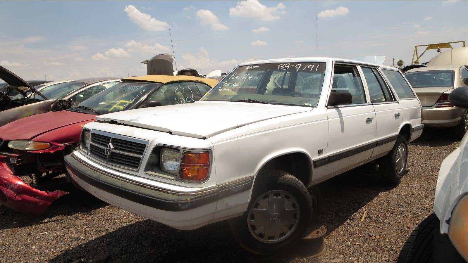 1988 Dodge Aries-K station wagon in Arizona wrecking yard.