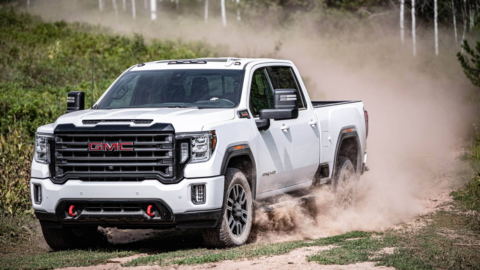2020 GMC Sierra HD AT4 driving down a dirt road
