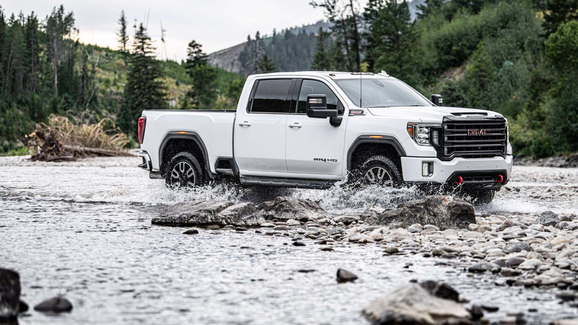 2020 GMC Sierra HD AT4 driving through a stream
