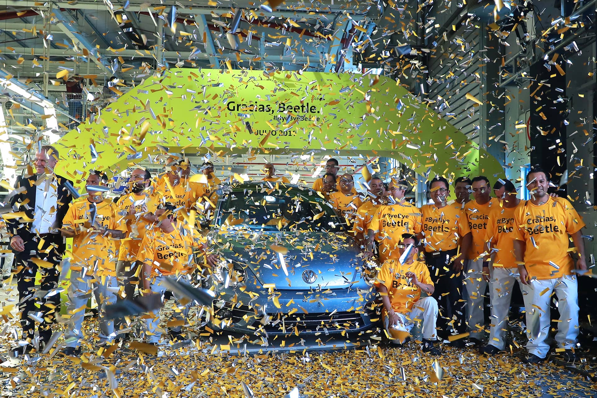 CUAUTLANCINGO, MEXICO - JULY 10: Workers and managers of Volkswagen pose with the last Beetle produced during a ceremony to announce the cease of the production of the VW Beetle after 21 years in the market, at Volkswagen Plant on July 10, 2019 in Cuautlancingo, Mexico. Considered as the successor of the Volkswagen Type 1, the Beetle was produced during 21 years in the Cuautlancingo plant, it is estimated that over 17 millions of units were produced. (Photo by Hector Vivas/Getty Images)