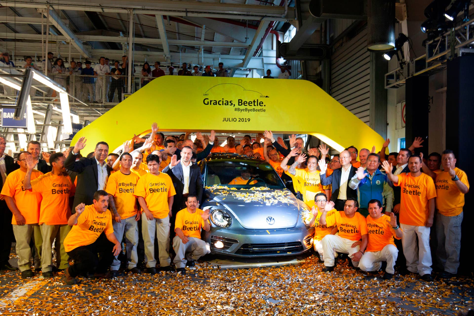 Volkswagen employees pose with a "Beetle", the final edition of the iconic car, at a factory in Puebla, Puebla State, Mexico, on July 10, 2019. - The bug-shaped metallic blue sedan rolled off the production line in central Mexico to rapturous applause, the last of a model first manufactured in the late 1930s. (Photo by JUAN CARLOS SANCHEZ / AFP)        (Photo credit should read JUAN CARLOS SANCHEZ/AFP/Getty Images)