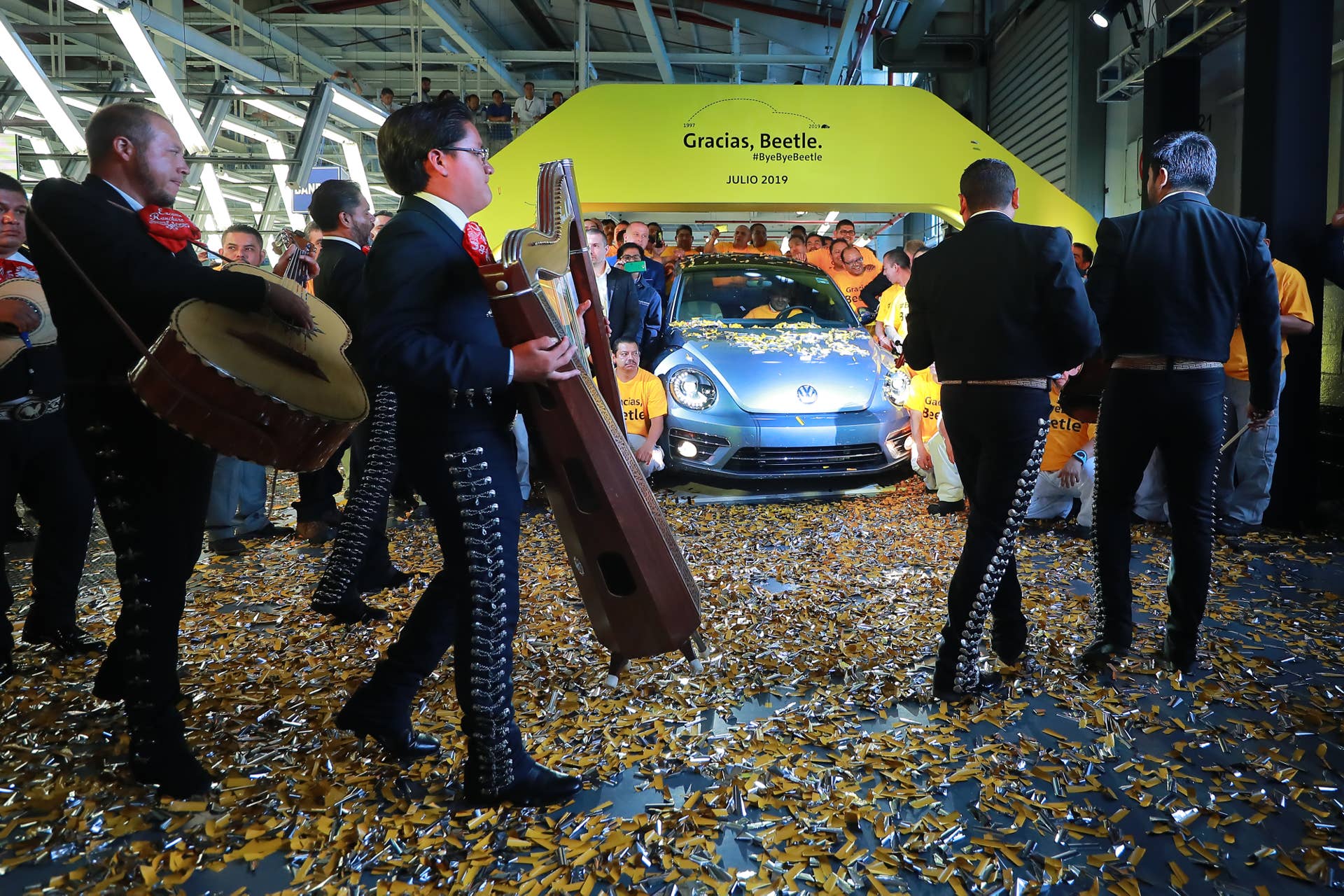 CUAUTLANCINGO, MEXICO - JULY 10: Mariachi musicians play songs with workers and managers of Volkswagen during a ceremony to announce the cease of the production of the VW Beetle after 21 years in the market, at Volkswagen Plant on July 10, 2019 in Cuautlancingo, Mexico. Considered as the successor of the Volkswagen Type 1, the Beetle was produced during 21 years in the Cuautlancingo plant, it is estimated that over 17 millions of units were produced. (Photo by Hector Vivas/Getty Images)