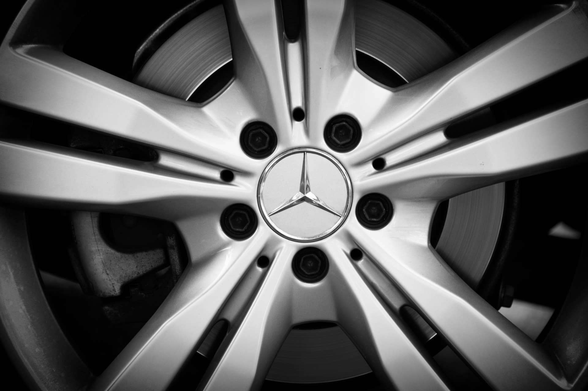 Padua, Italy - July 8, 2012: Mercedes-Benz metallic logo on a car rim. Mercedes-Benz (division of Daimler AG) is a German manufacturer of automobiles, buses, coaches, and trucks. It is famous all over the world for high quality, elegant and durable products. Shot in a public parking.
