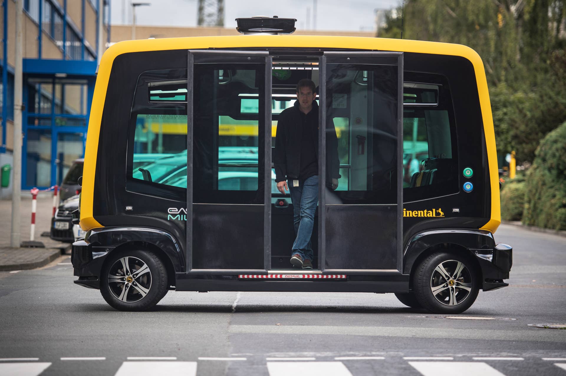 An employee alights from a Cube autonomous robo-taxi, manufactured by Continental AG, in Frankfurt, Germany, on Wednesday, Sept. 6, 2017. The German government adopted a self-driving car technology action plan on Aug. 23 that includes legal and ethical guidelines for the vehicles. Photographer: Andreas Arnold/Bloomberg via Getty Images