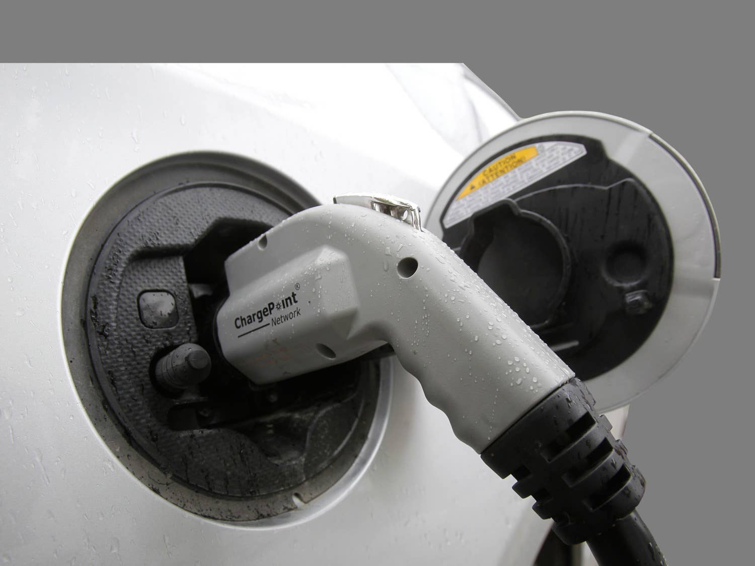 Electric vehicle plugged in at a charging station, Montpelier, Vermont, graphic element on gray