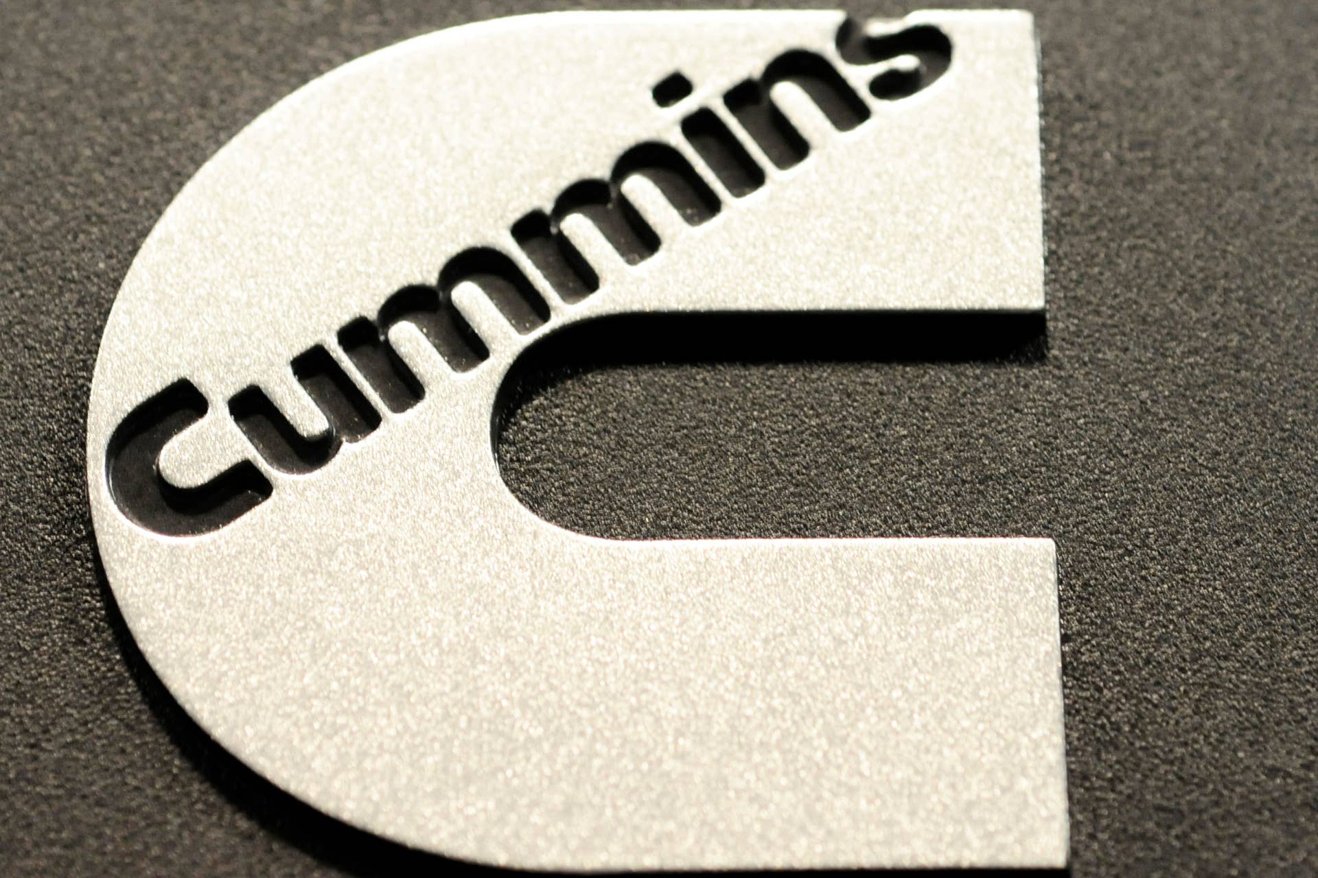 The Cummins Inc. logo is seen an engine part at the Cummins engine plant in Walesboro, Indiana, U.S, on Thursday, May 5, 2011. Demand from emerging economies like China, the need to replenish stockpiles an investment in new equipment may keep benefitting manufacturers like Cummins Inc. Photographer: Tom Strickland/Bloomberg via Getty Images