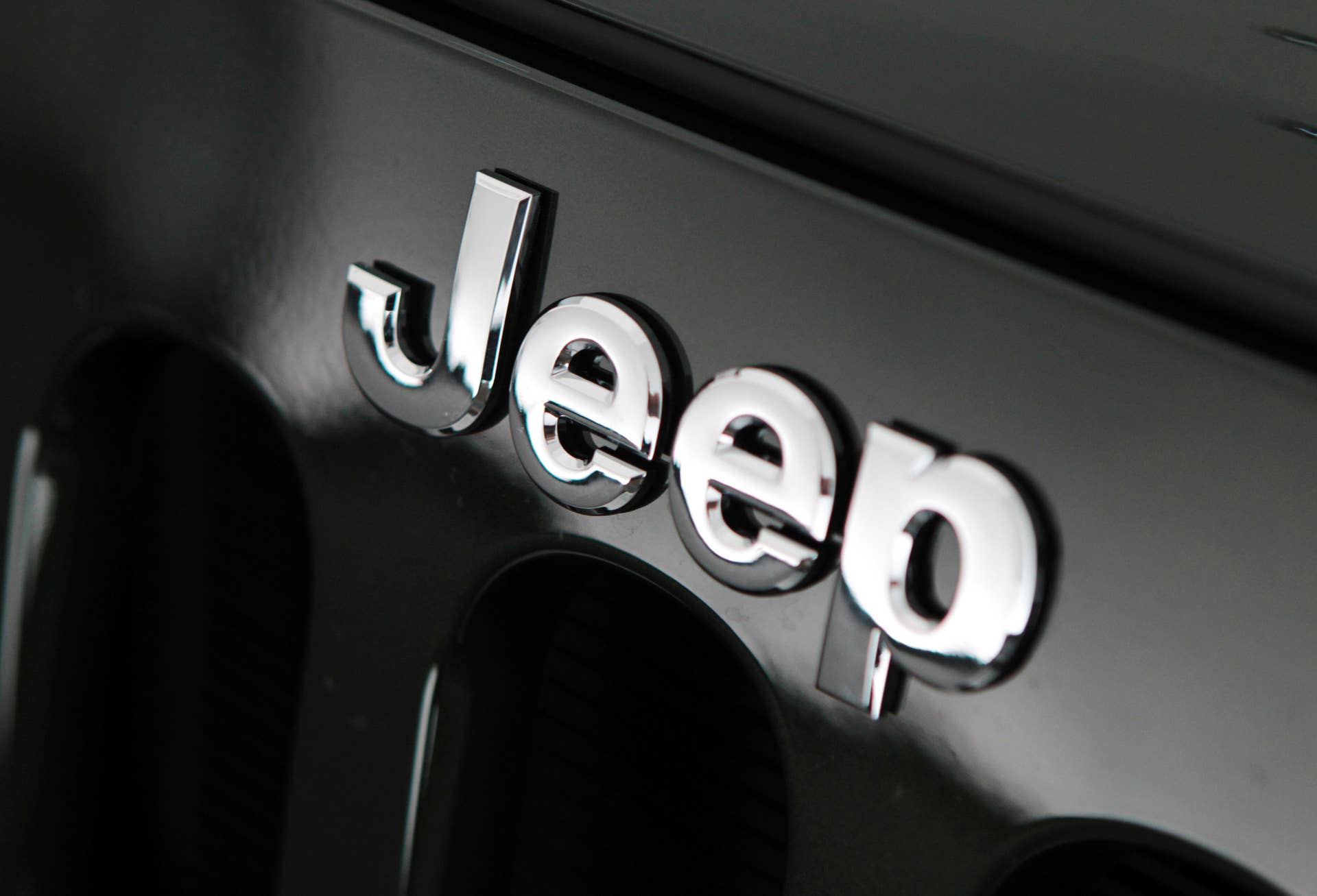 The Jeep badge appears on the grille of a 2011 Wrangler Sahara edition sport utility vehicle (SUV) during a media event at Chrysler Group LLC's design dome in Auburn Hills, Michigan, U.S. on Monday, Sept. 20, 2010. Members of the Jeep design team presented new and updated 2011 Jeep Wrangler, Patriot and Grand Cherokee models. Photographer: Jeff Kowalsky/Bloomberg via Getty Images