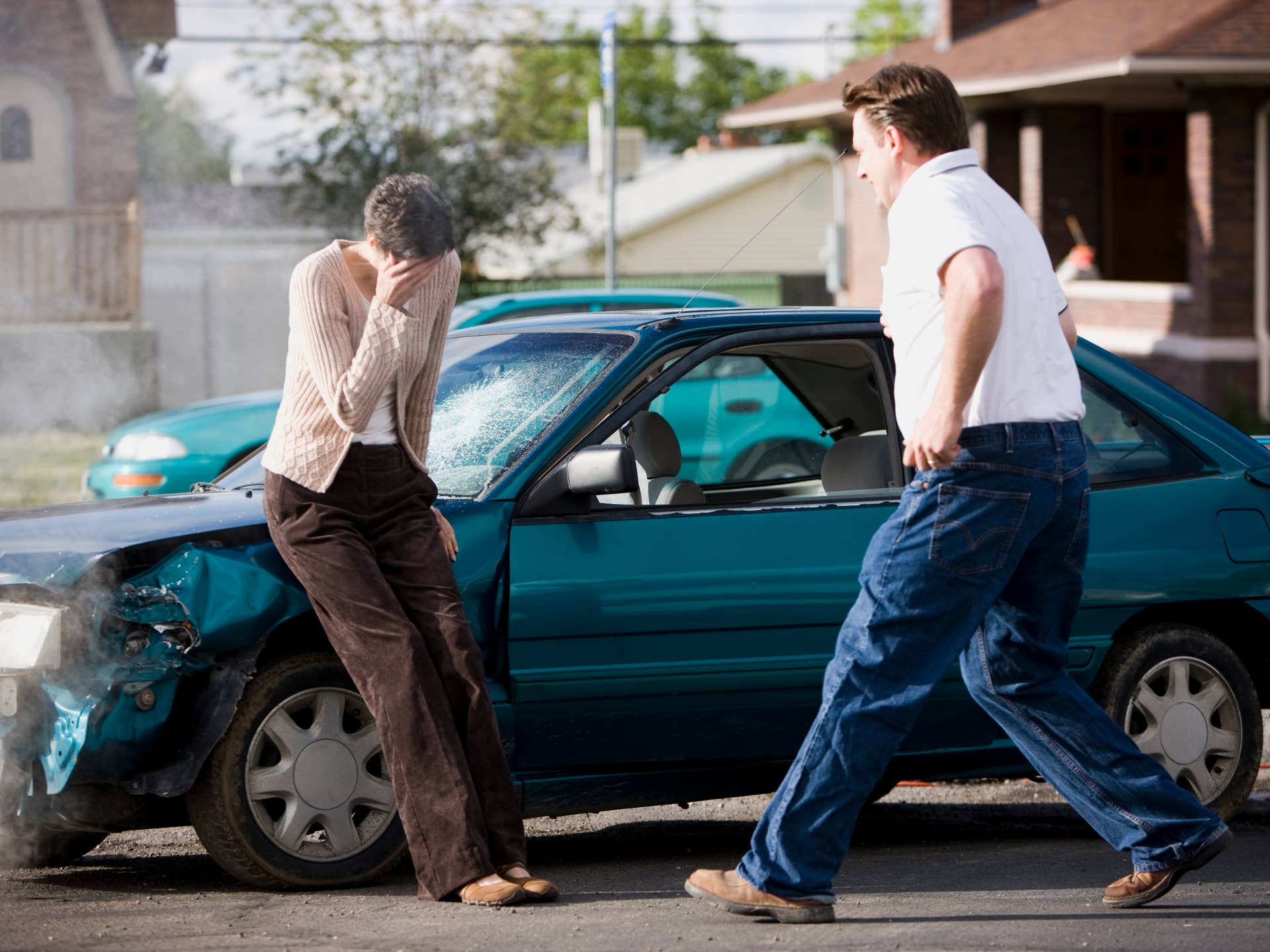 man helping a woman after a car accident