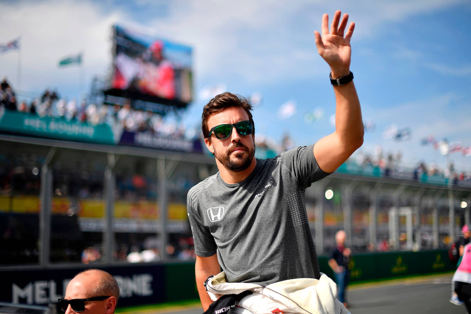 McLaren's Spanish driver Fernando Alonso takes part in the drivers parade prior to the start of the Formula One Australian Grand Prix in Melbourne on March 26, 2017. / AFP PHOTO / SAEED KHAN / --IMAGE RESTRICTED TO EDITORIAL USE - STRICTLY NO COMMERCIAL USE-- (Photo credit should read SAEED KHAN/AFP/Getty Images)