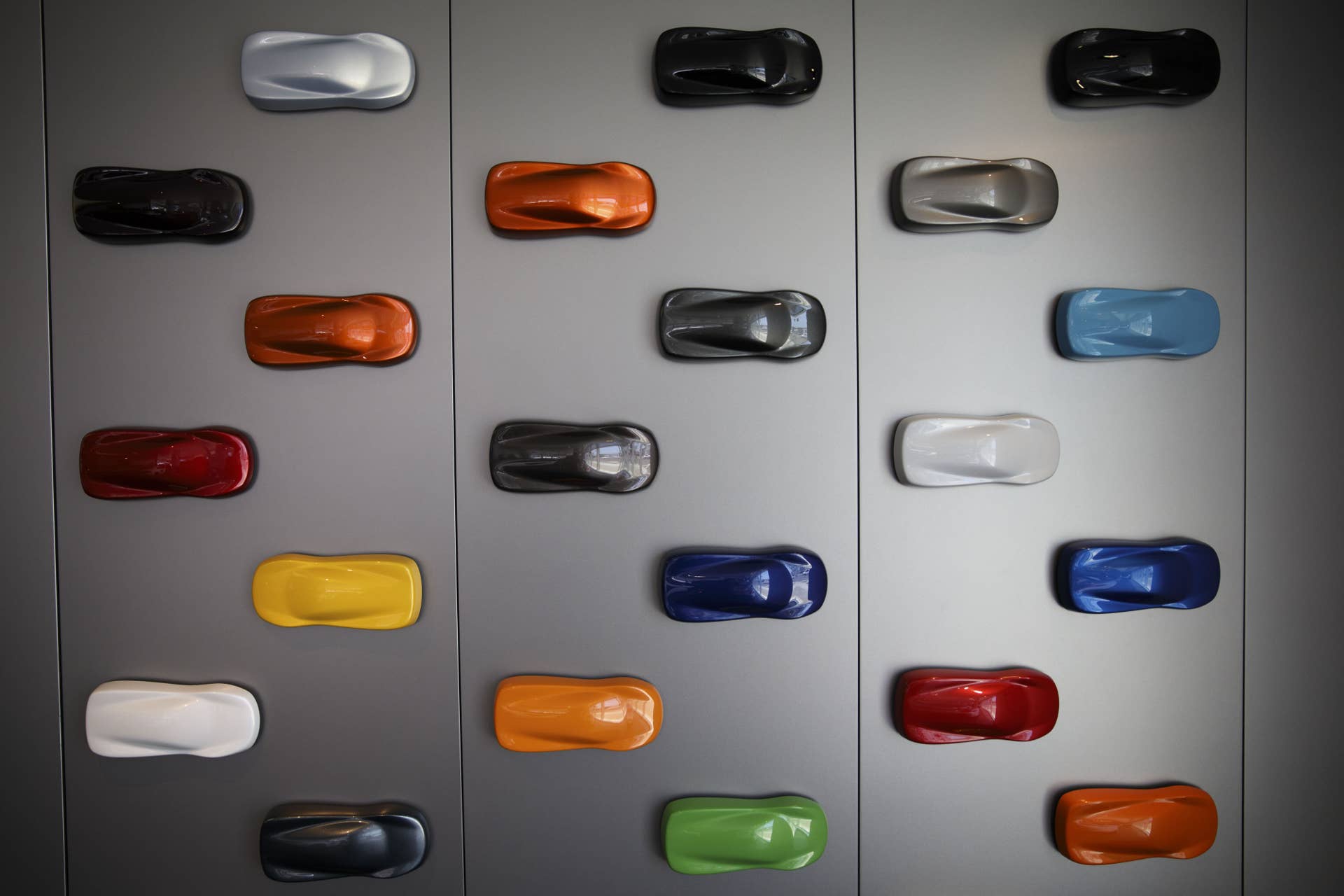 Paint choices for vehicles are displayed on a wall inside the McLaren Newport Beach dealership in Newport Beach, California, U.S., on Tuesday, July 25, 2017. While offering more 'practical' cars, such as this year's 570 Spider convertible, put the brand within reach of a larger customer base, its expansion last year when sales in North America more than doubled was spurred by the offering of leases through Ally Financial Inc. Whereas a 650S would lease for maybe $3,500 a month, you can drive a 570S for more like $2,500 a month. Photographer: Patrick T. Fallon/Bloomberg via Getty Images