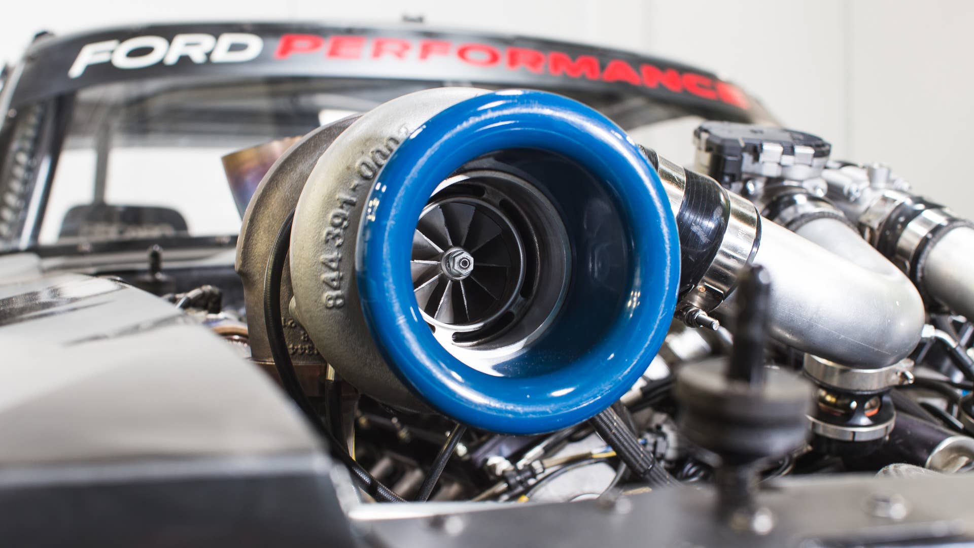 For fuel, the buffed Hoonicorn runs methanol due to its ability to keep temperatures low. Despite its two turbos, the ’65 Mustang does not require the use of any intercoolers. Wonder why Ken Block is wearing a mask? It’s because the fumes from methanol are toxic, burning eyes and lungs. If that isn’t frightening enough, methanol fires are nearly invisible in sunlight, as the flames are colorless and produce no smoke.