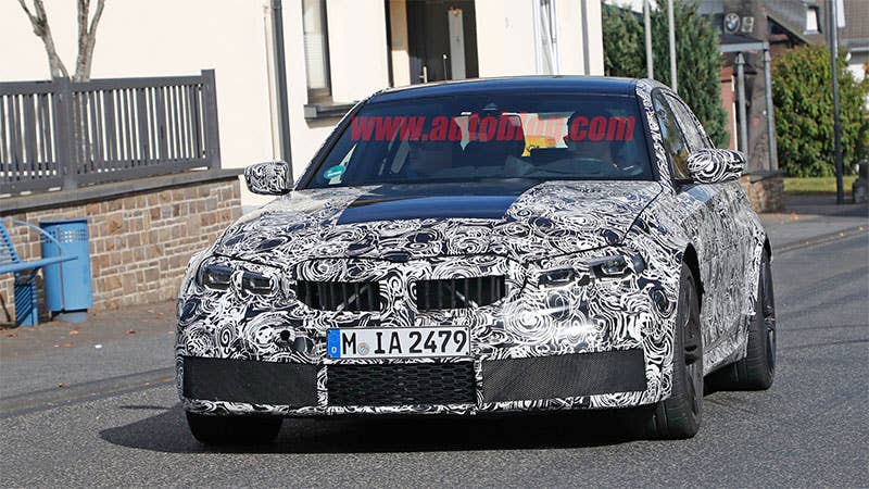 CarPix spy photographers capture a camouflaged 2020 BMW M3 testing around the Nurburgring, front three-quarter view.