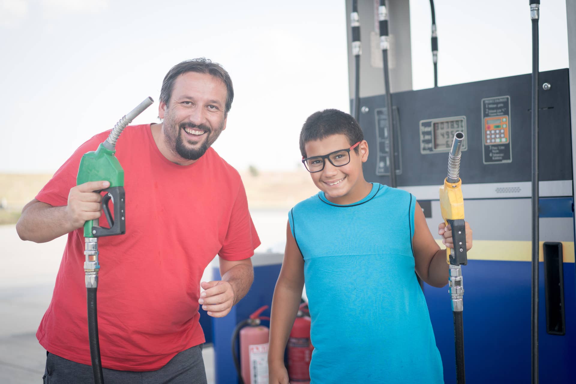 Man and child on gas station