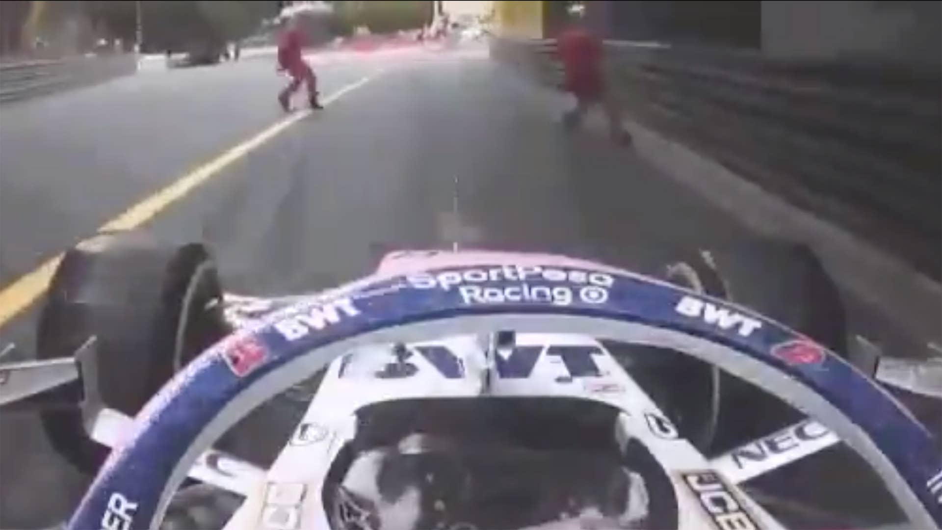 Two F1 track marshals accidentally ran in front of Sergio Pérez.