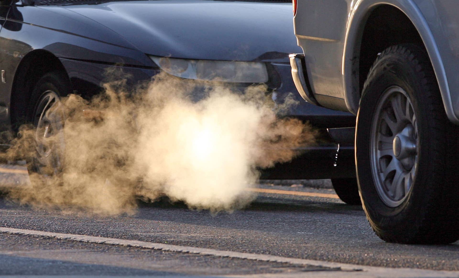 A cloud of smoke and water vapor blows from muffler, March 4, 2010, of a pick-up stopped at a traffic light on Lee Road in Orlando, Florida. Lower speed limits, tailpipe checks and commuter lanes could be in the offering because of more stringent smog regulations proposed by the federal government. (Photo by Red Huber/Orlando Sentinel/MCT via Getty Images)