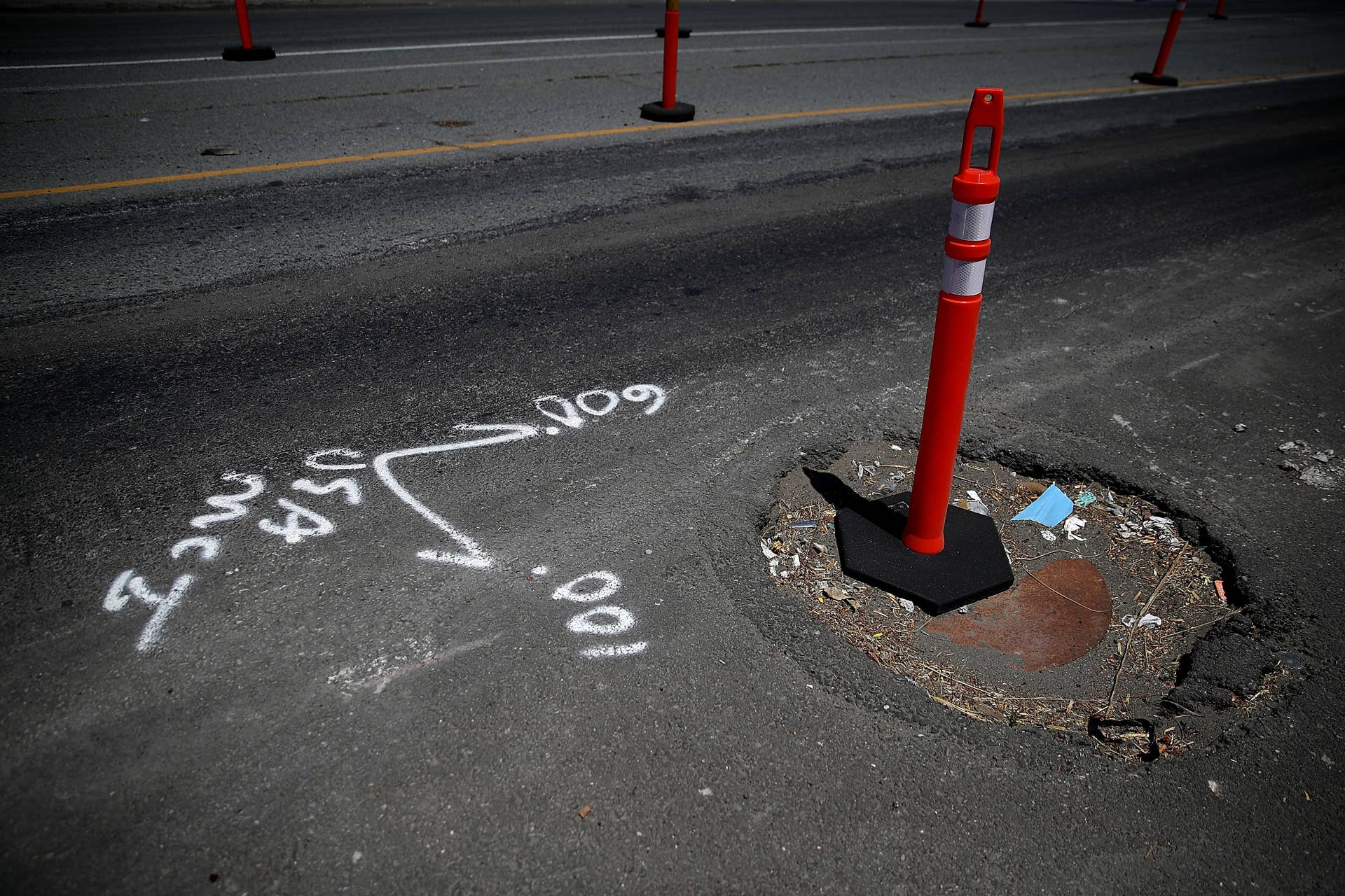 OAKLAND, CA - JULY 12: A traffic delineator stands in a pothole on July 12, 2017 in Oakland, California. According to a report by WalletHub, roads in San Francisco, Oakland and four other California cities are the worst in the United States. Drivers in San Francisco and Oakland pay an estimated $978 per year to repair vehicle damage from driving on roads with potholes and uneven pavement. (Photo by Justin Sullivan/Getty Images)