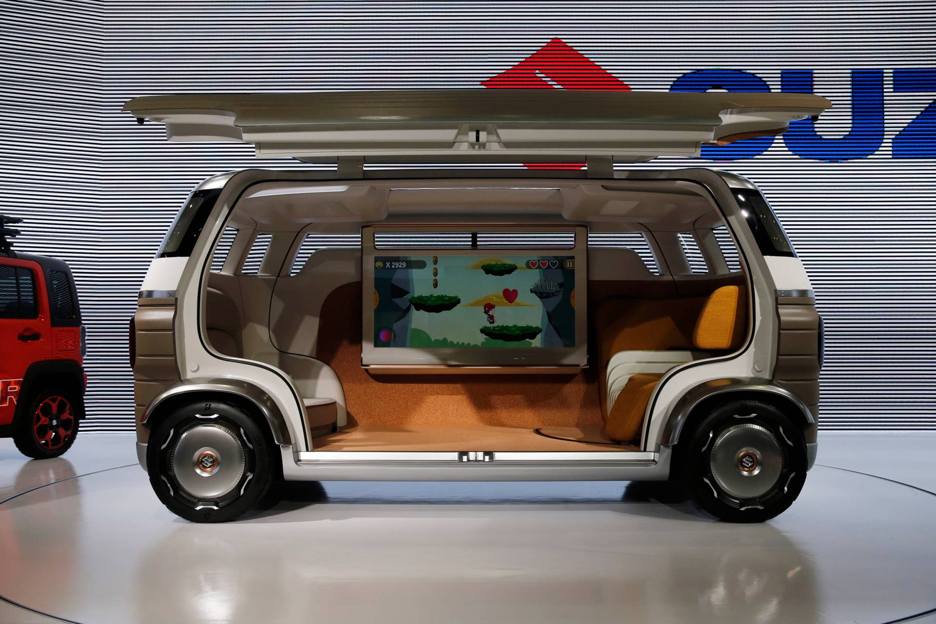 A Suzuki Hanare is displayed during the media preview of the Tokyo Motor Show Wednesday, Oct. 23, 2019, in Tokyo, Japan. (AP Photo/Kiichiro Sato)