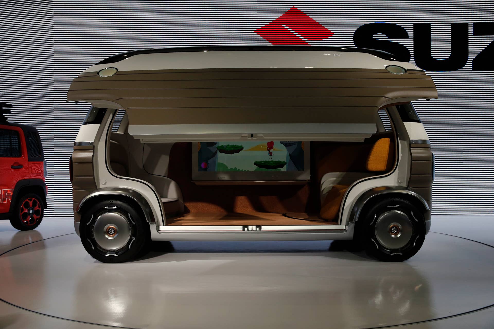 A Suzuki Hanare is displayed during the media preview of the Tokyo Motor Show Wednesday, Oct. 23, 2019, in Tokyo. (AP Photo/Kiichiro Sato)