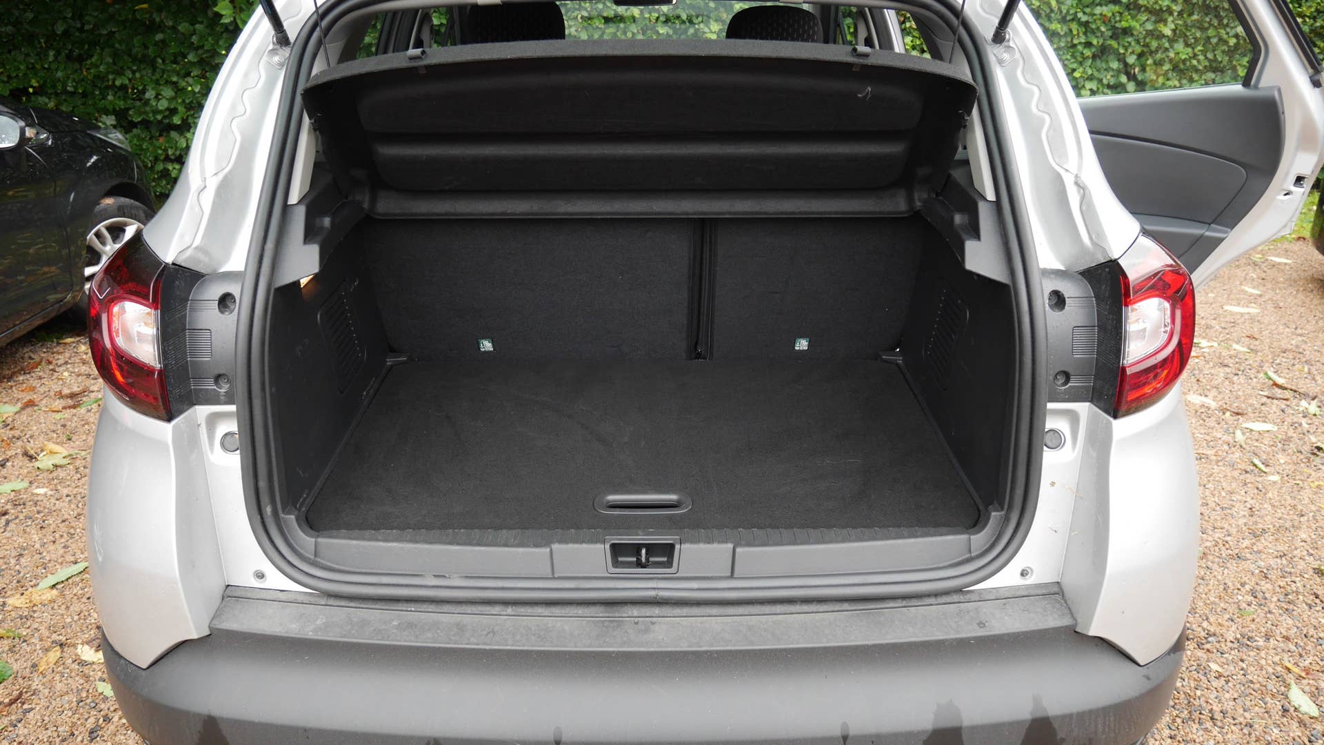 The cargo area with the back seat slid back and the floor in place.