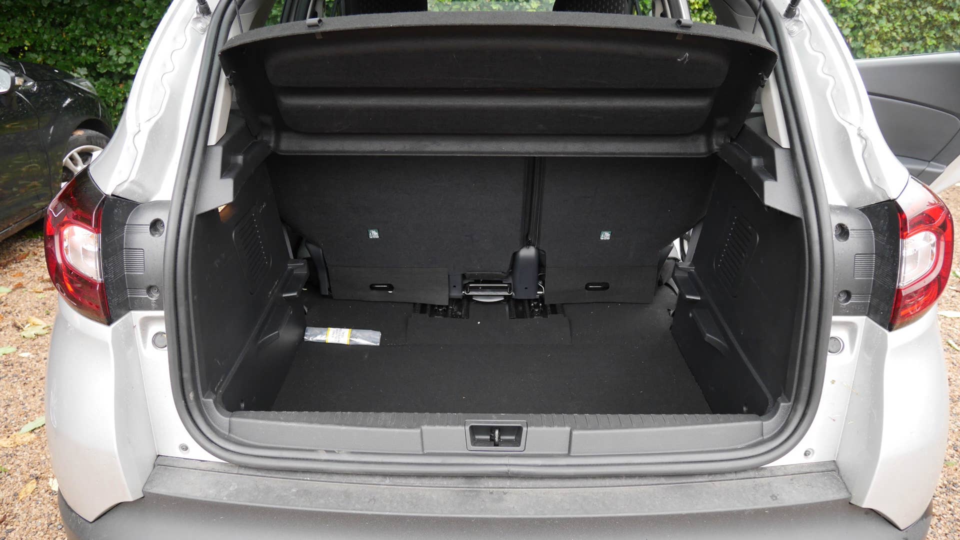 The cargo area with the seat slid forward and the floor removed.