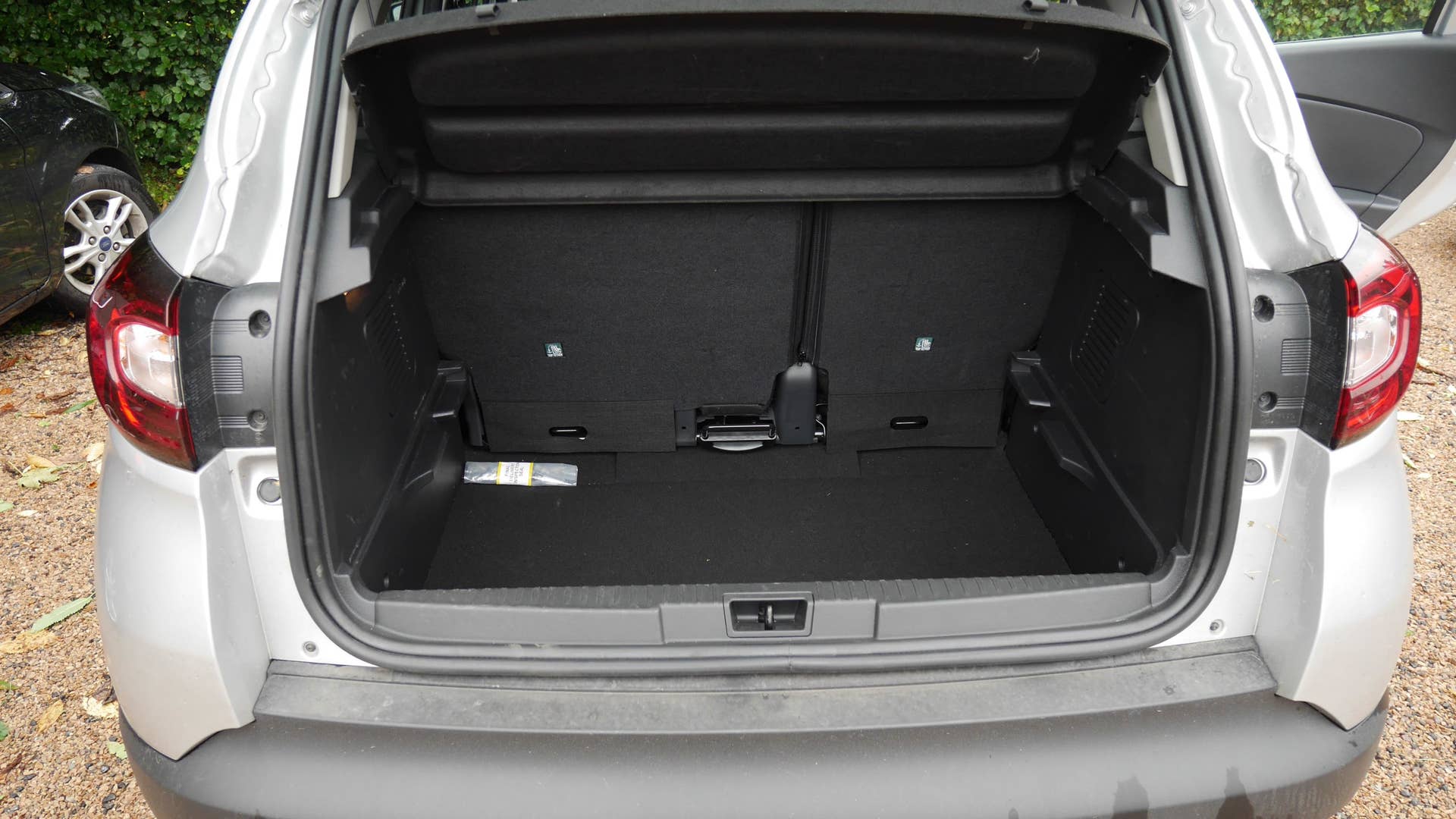 The cargo area with the seat slid back and the floor removed.
