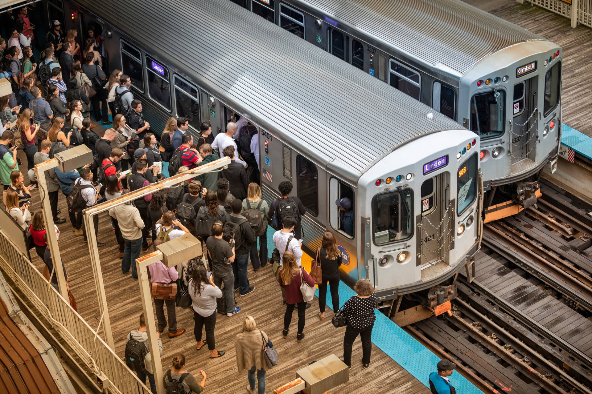 Chicago, Illinois, USA - September 24, 2018: Commuters wait on the platform for the elevated train on the tracks in the Loop area of downtown Chicago Illinois USA