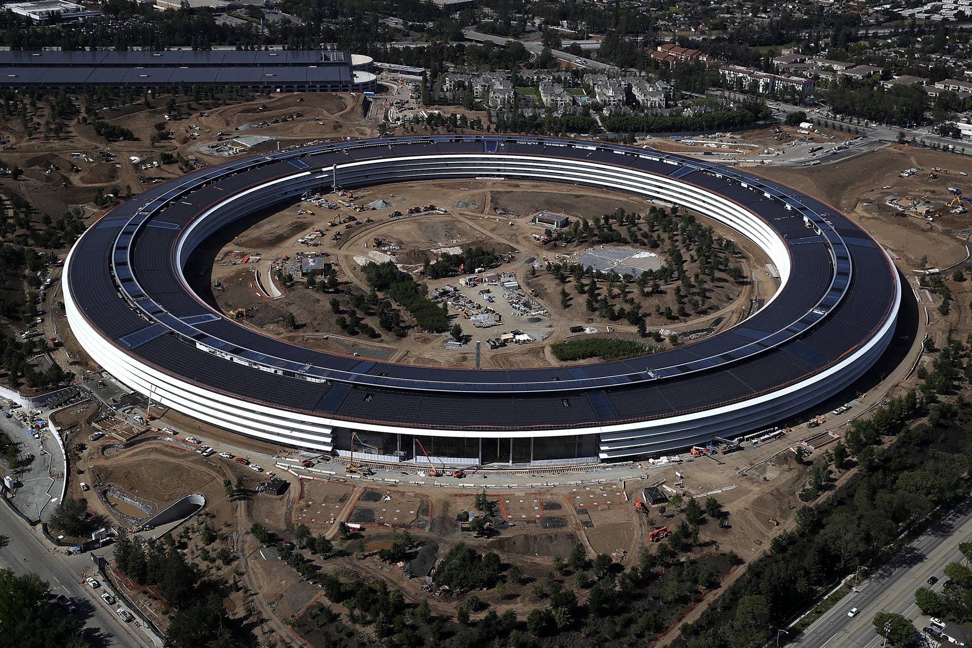 CUPERTINO, CA - APRIL 28: An aerial view of the new Apple headquarters on April 28, 2017 in Cupertino, California. Apple's new 175-acre 'spaceship' campus dubbed 'Apple Park' is nearing completion and is set to begin moving in Apple employees. The new headquarters, designed by Lord Norman Foster and costing roughly $5 billion, will house 13,000 employees in over 2.8 million square feet of office space and will have nearly 80 acres of parking to accommodate 11,000 cars. (Photo by Justin Sullivan/Getty Images)