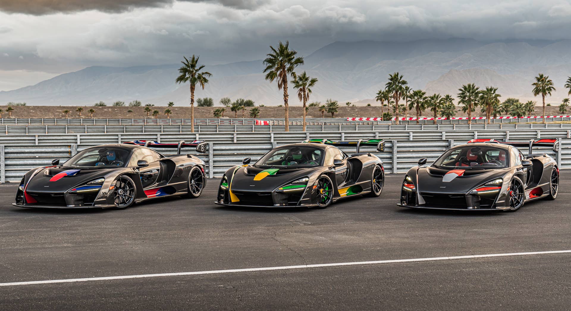 Each car gets a name and celebrates a Formula 1 race track where Ayrton Senna scored an especially outstanding victory. All three are dressed in gloss black carbon fiber, accented with the colors of the F1 circuit's country, and adorned with Ayrton's car number on the wing endplates.