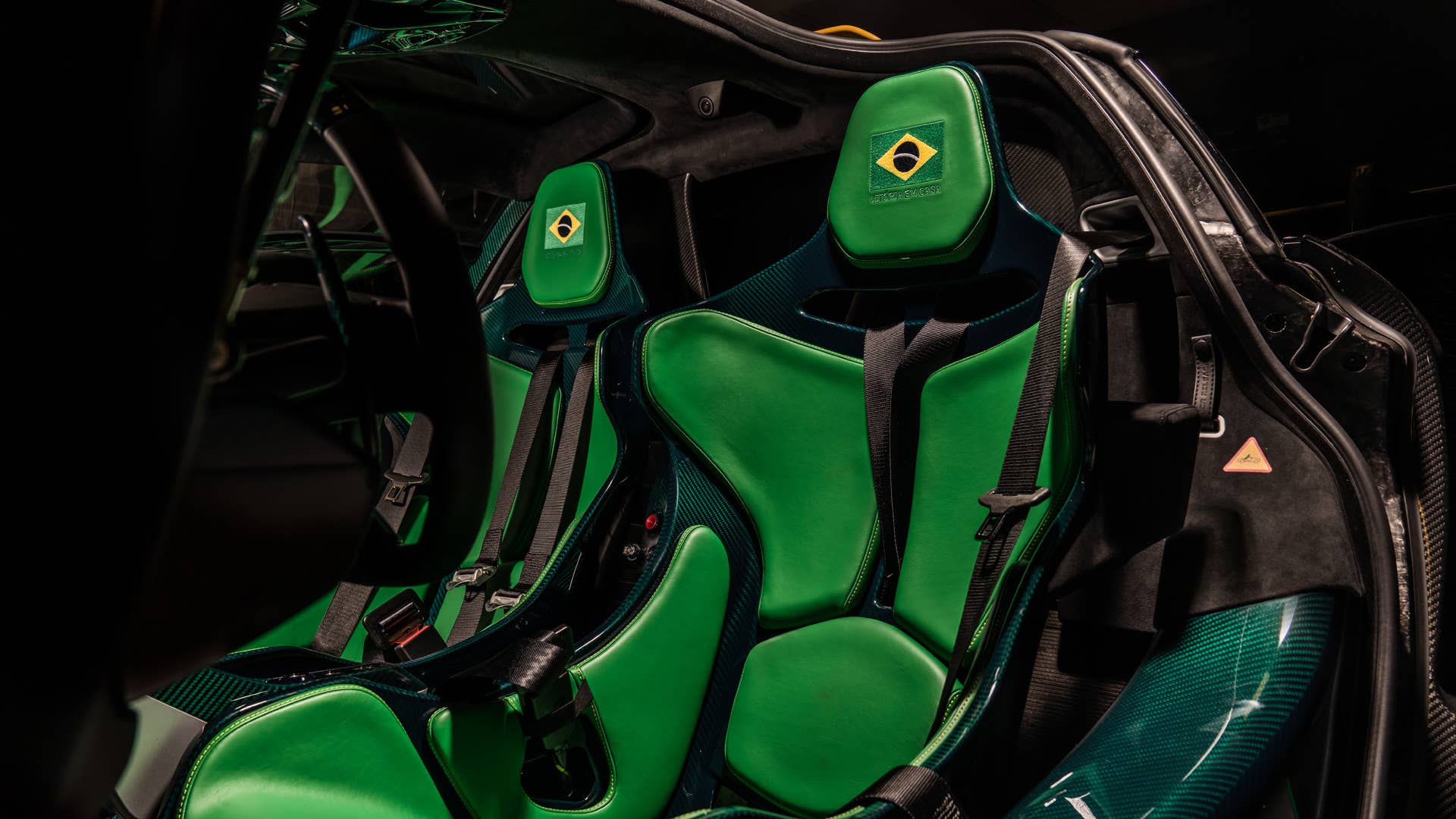 Each car gets a name and celebrates a Formula 1 race track where Ayrton Senna scored an especially outstanding victory. All three are dressed in gloss black carbon fiber, accented with the colors of the F1 circuit's country, and adorned with Ayrton's car number on the wing endplates.