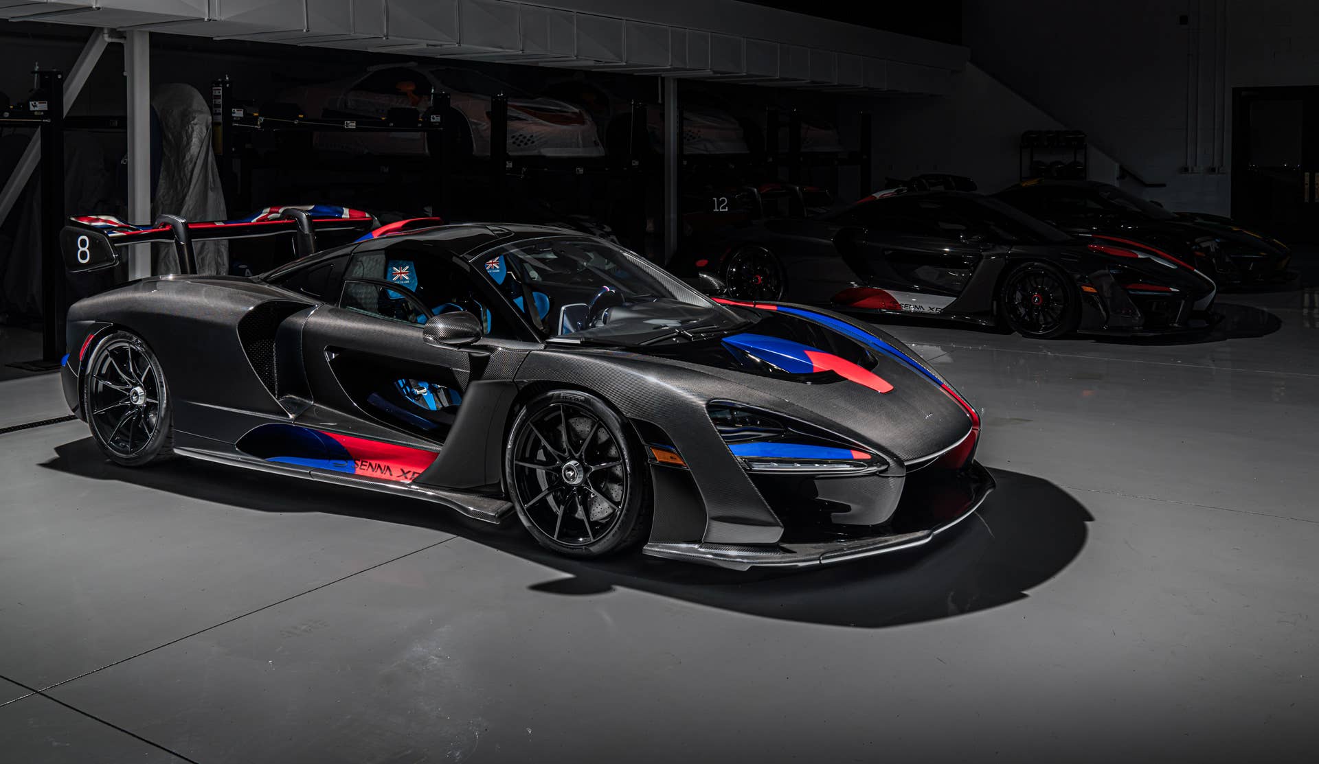Each car gets a name and celebrates a Formula 1 race track where Ayrton Senna scored an especially outstanding victory. All three are dressed in gloss black carbon fiber, accented with the colors of the F1 circuit's country, and adorned with Ayrton's car number on the wing endplates.