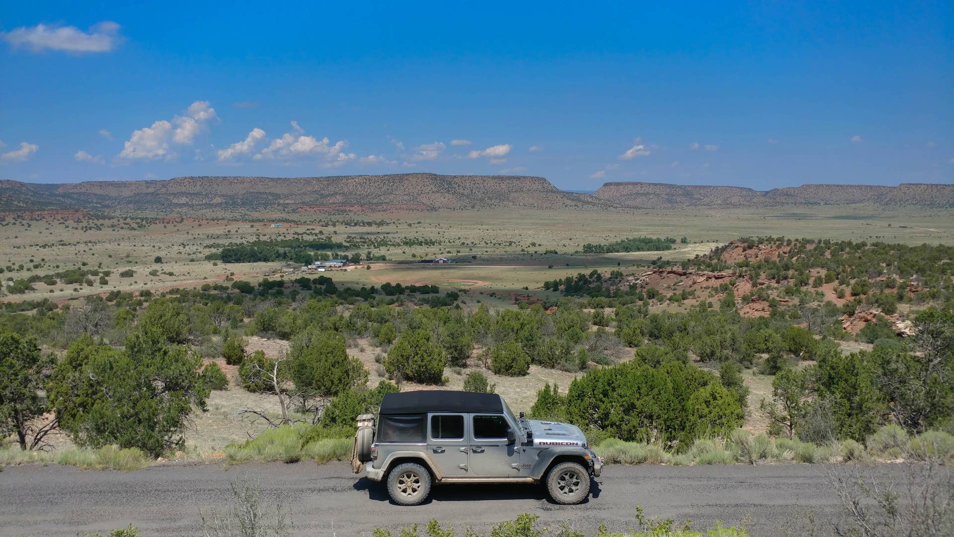 Pass through a tight right-left combo on Lake Road in Grenville, NM and the elevated plain land falls away to miles of valleys defined by towering rails of rock. Welcome to the West.