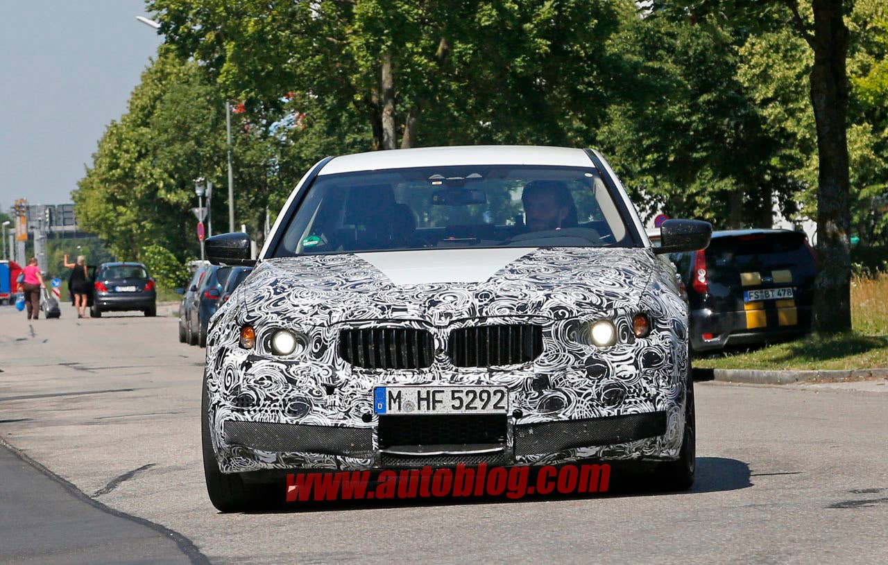 camouflaged bmw m5 spy shots front on