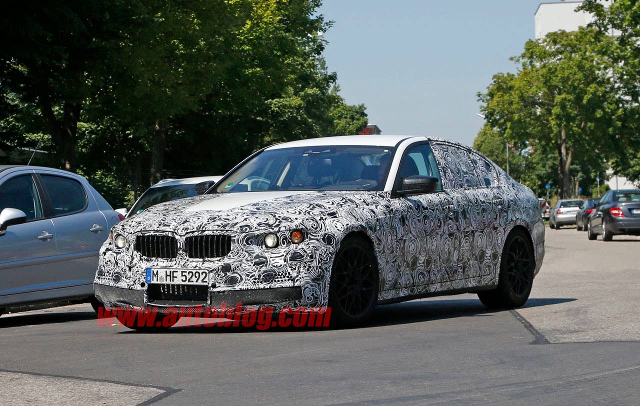 camouflaged bmw m5 spy shots low angle three quarters