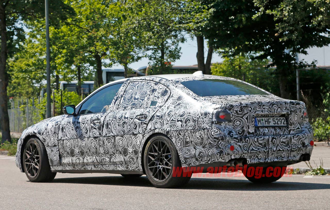 camouflaged bmw m5 spy shots rear three quarters
